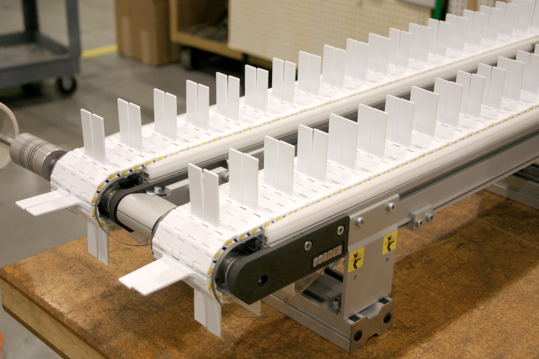 Gang drive conveyor system with flighted belt.